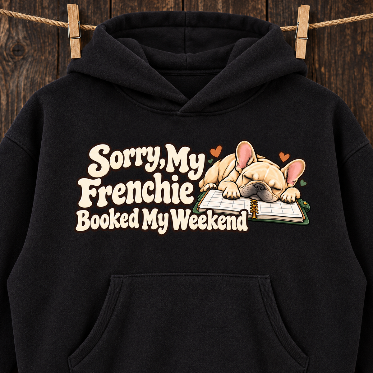 Close-up of the Sorry, My Frenchie Booked My Weekend front print on a black French Bulldog hoodie.