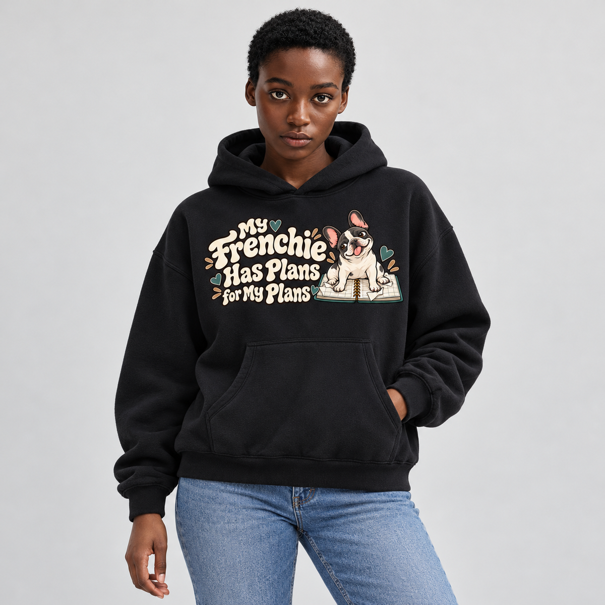Woman wearing a black French Bulldog hoodie with the My Frenchie Has Plans for My Plans front print.