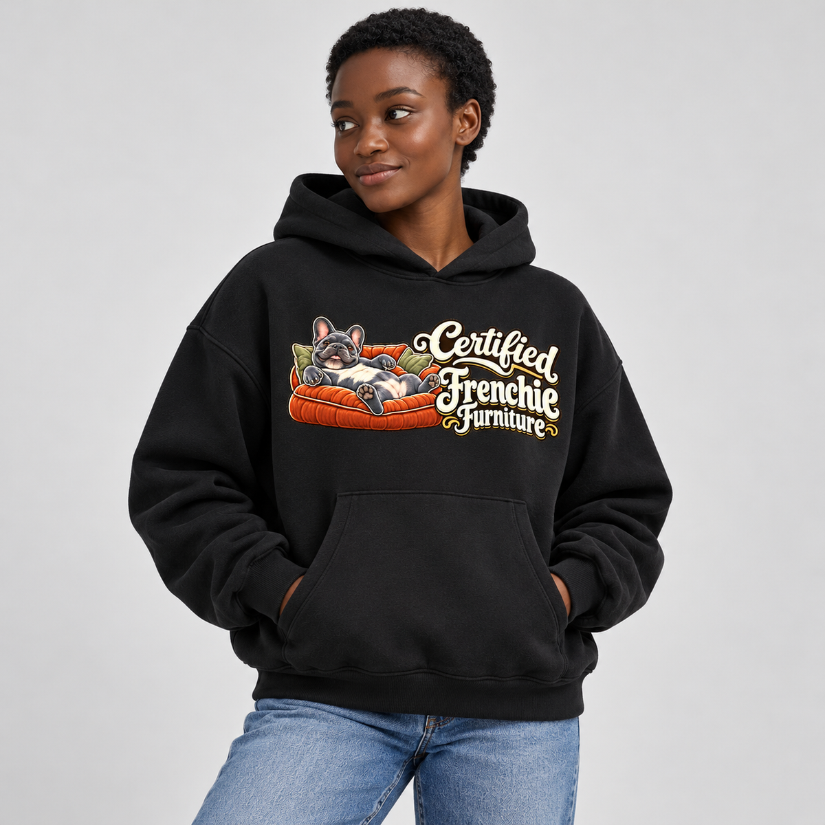 Woman wearing a black French Bulldog hoodie with the Certified Frenchie Furniture front print.