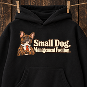 Woman wearing a black French Bulldog hoodie with the Small Dog. Management Position front print.