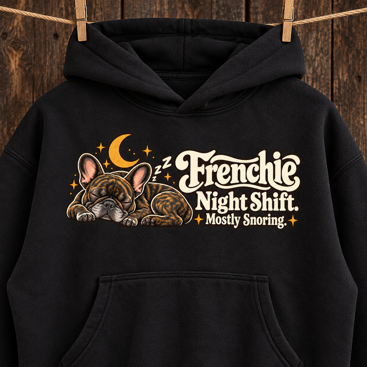 Close-up of the Frenchie Night Shift. Mostly Snoring front print on a black French Bulldog hoodie.