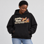 Woman wearing a black French Bulldog hoodie with the Frenchie Mom. Snack Department front print.