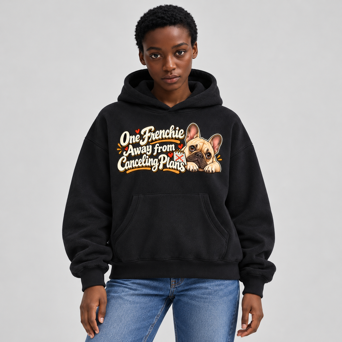 Woman wearing a black French Bulldog hoodie with the One Frenchie Away from Canceling Plans front print.