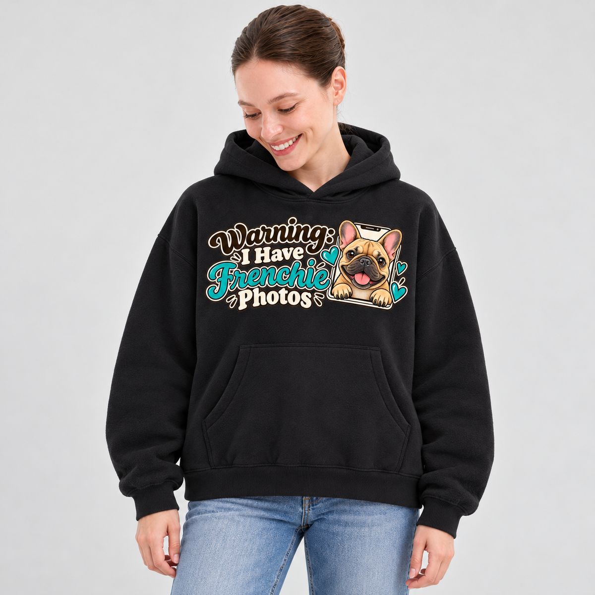 Woman wearing a black French Bulldog hoodie with the Warning: I Have Frenchie Photos front print.