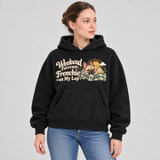 Woman wearing a black French Bulldog hoodie with the Weekend Forecast: Frenchie on My Lap front print.