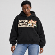 Woman wearing a black French Bulldog hoodie with the Sorry, My Frenchie Booked My Weekend front print.