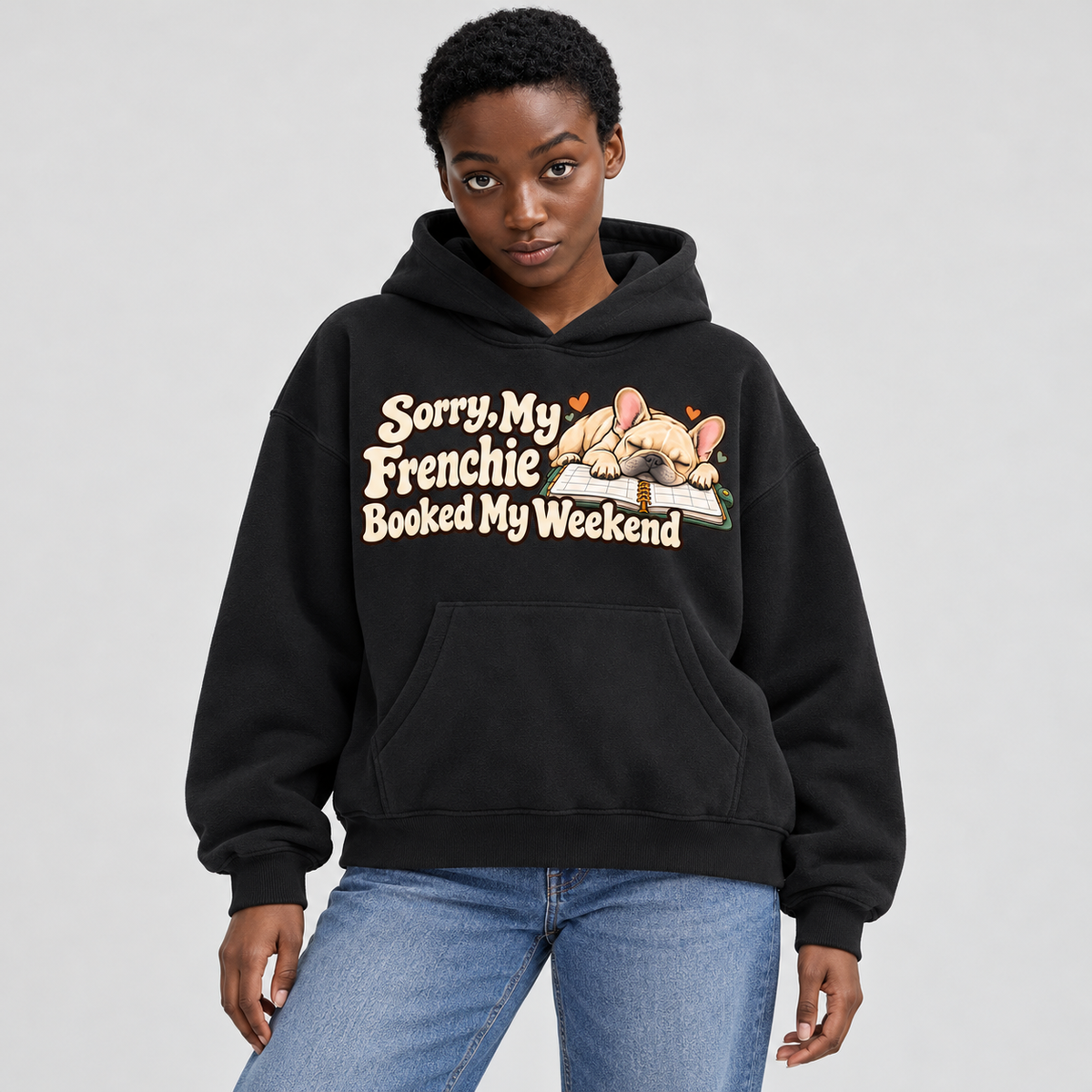 Woman wearing a black French Bulldog hoodie with the Sorry, My Frenchie Booked My Weekend front print.