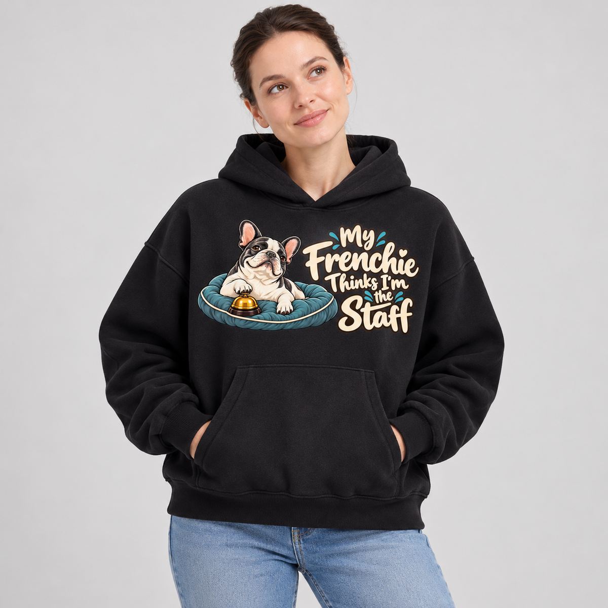 Woman wearing a black French Bulldog hoodie with the My Frenchie Thinks I'm the Staff front print.