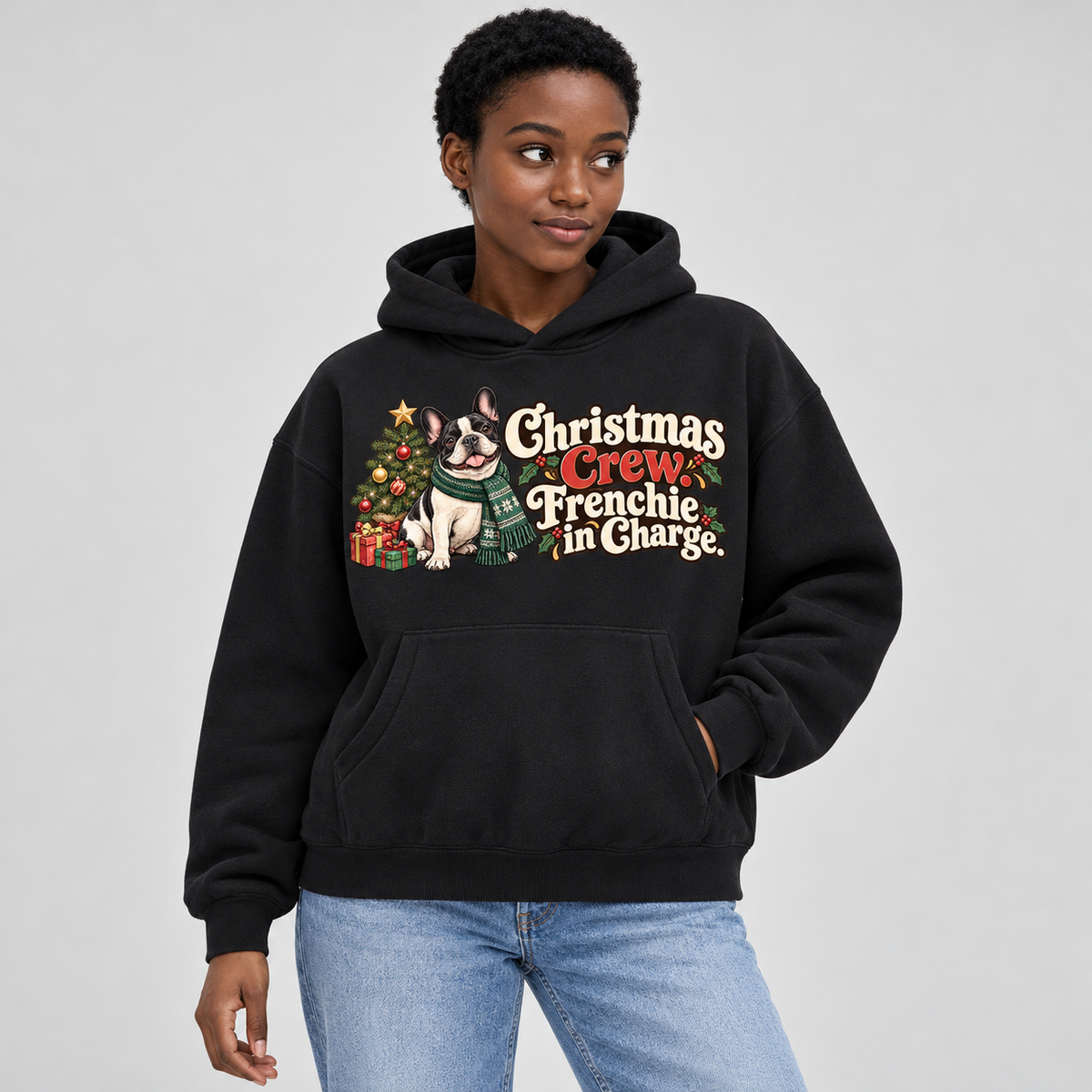 Woman wearing a black French Bulldog hoodie with the Christmas Crew. Frenchie in Charge front print.