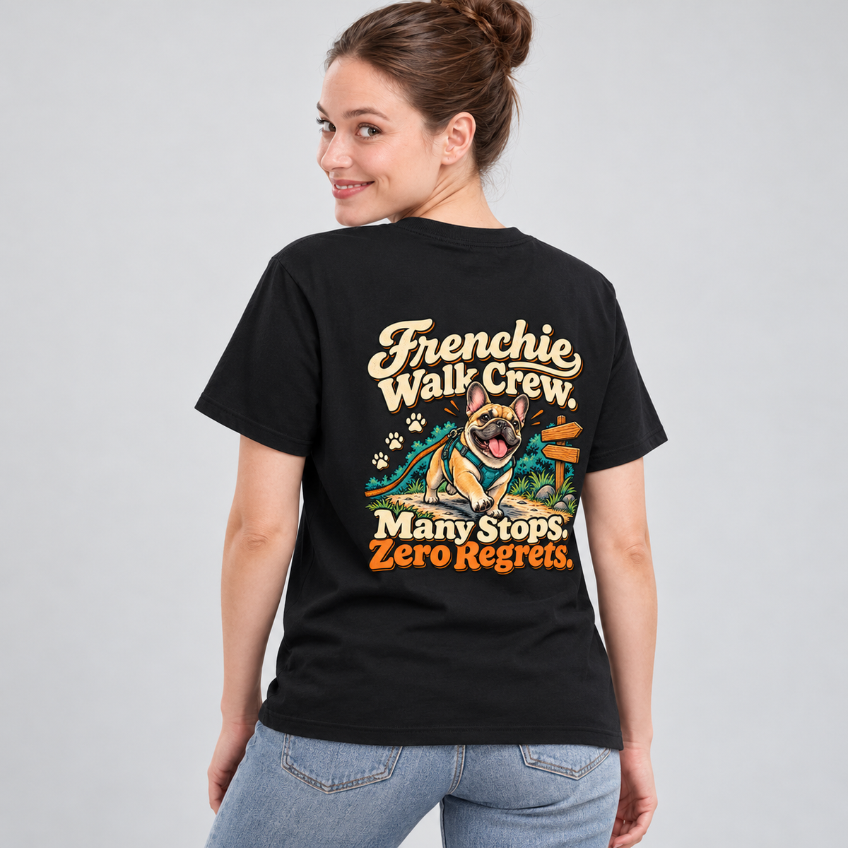 Close-up of Frenchie Walk Crew. Many Stops. Zero Regrets. artwork on the back of a black cotton T-shirt