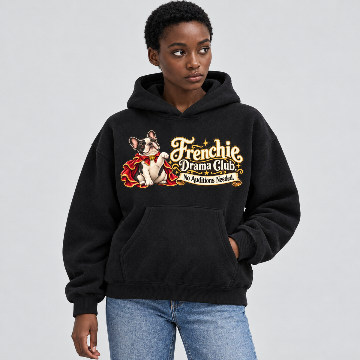 Woman wearing a black French Bulldog hoodie with the Frenchie Drama Club. No Auditions Needed front print.