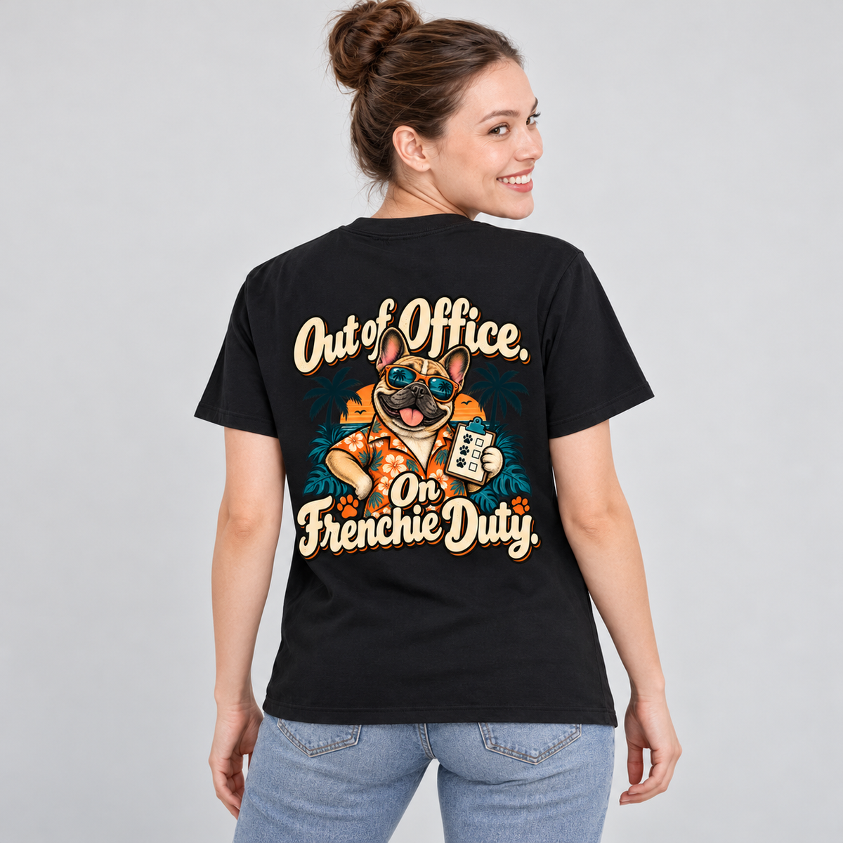 Model wearing a black French Bulldog T-shirt with the Out of Office. On Frenchie Duty. artwork on the back