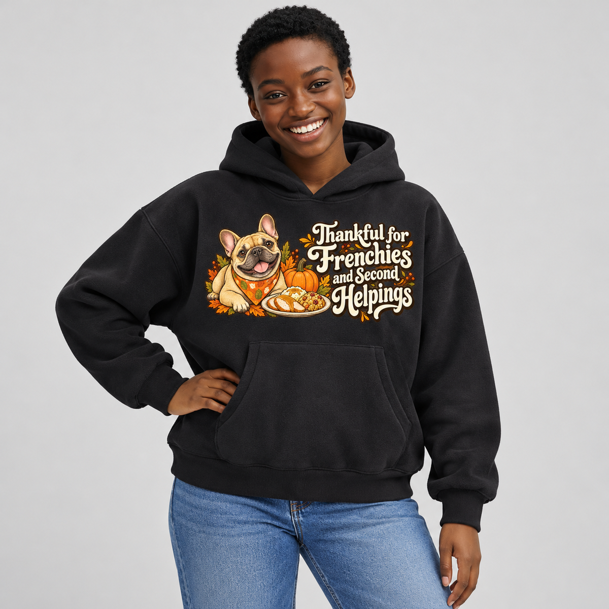Woman wearing a black French Bulldog hoodie with the Thankful for Frenchies and Second Helpings front print.