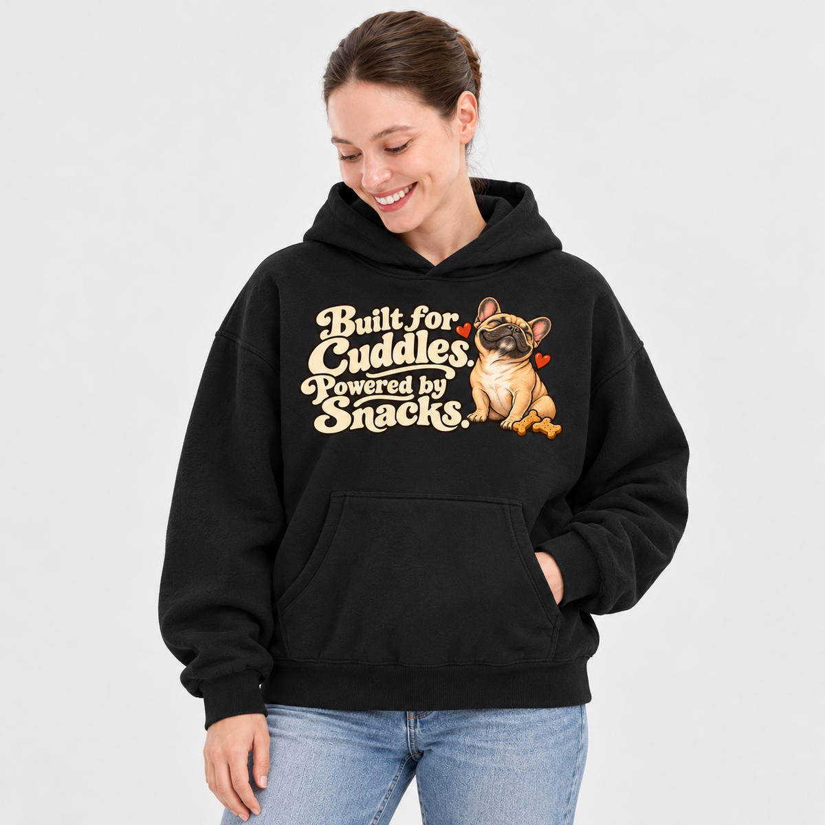 Woman wearing a black French Bulldog hoodie with the Built for Cuddles. Powered by Snacks front print.