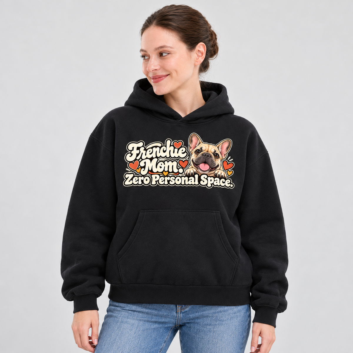 Woman wearing a black French Bulldog hoodie with the Frenchie Mom. Zero Personal Space front print.
