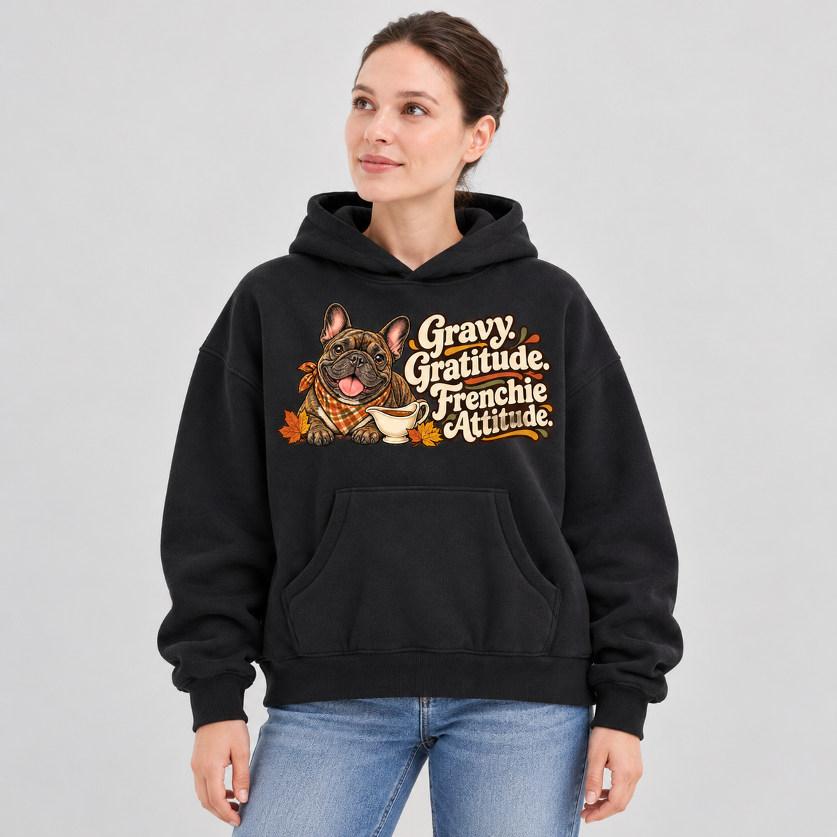Woman wearing a black French Bulldog hoodie with the Gravy. Gratitude. Frenchie Attitude front print.