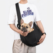 French Bulldog in black sling carrier bag