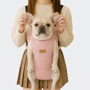 French Bulldog in pink fleece-lined backpack carrier