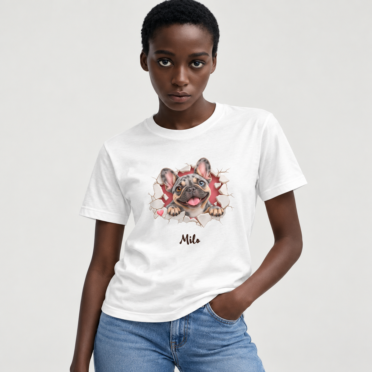 Approved model wearing the personalized merle Frenchie white T-shirt on a light gray studio background